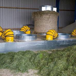 De laatste balen van vorig jaar staan nog op de grondbak. Als de balen nog vers zijn, worden ze hierop in twee tot drie dagen nagedroogd. De lucht wordt er van onderaf doorheen geblazen. De droogkosten bedragen € 4 à €4,50 per baal. „Als je ze inwikkelt i