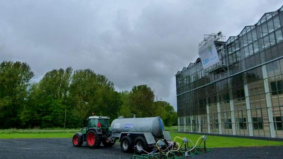 De weidewasser, die mestflatten met water verwijdert, komt niet in actie vanwege het natte weer. Studenten haalden het apparaat de vorige dag met de trekker op bij proefboerderij Zegveld (Z.H.).