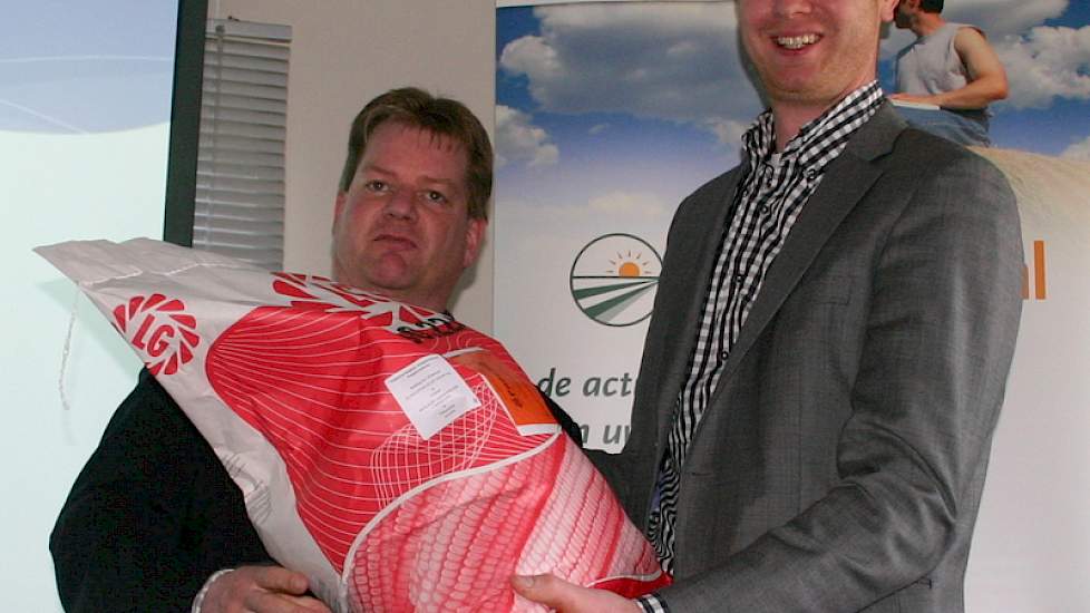 NAJK-voorzitter Wilko de Jong neemt de eerste zak LG 30.224 zaaizaad in ontvangst van Jos Groot Koerkamp, commercieel manager veehouderij bij Limagrain.
